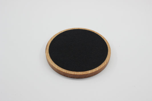 Underside of solid oak drinks coaster showing protective felt backing