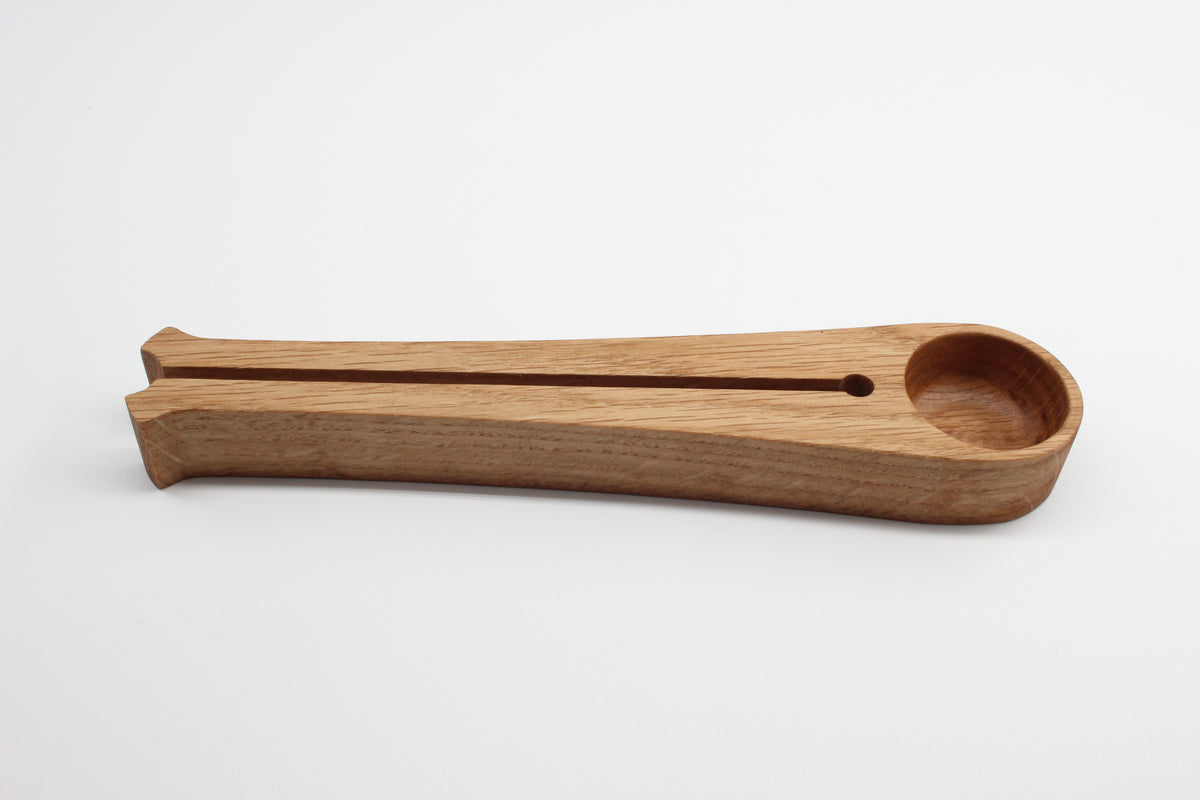 Side view of oak coffee scoop with integrated bag clip