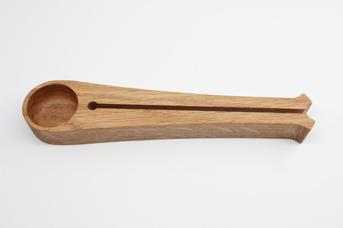 Traditional oak coffee scoop showing measuring bowl