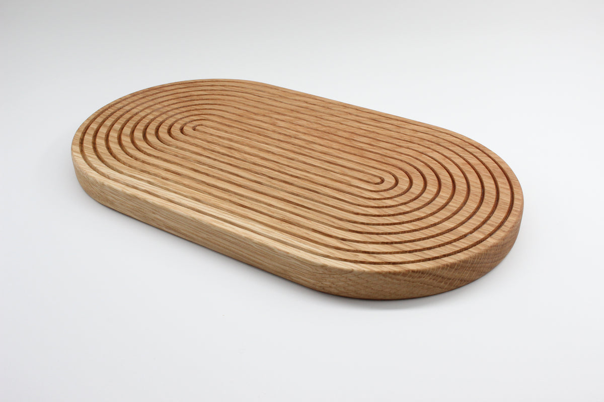 Solid oak trivet showing precision-cut groove pattern