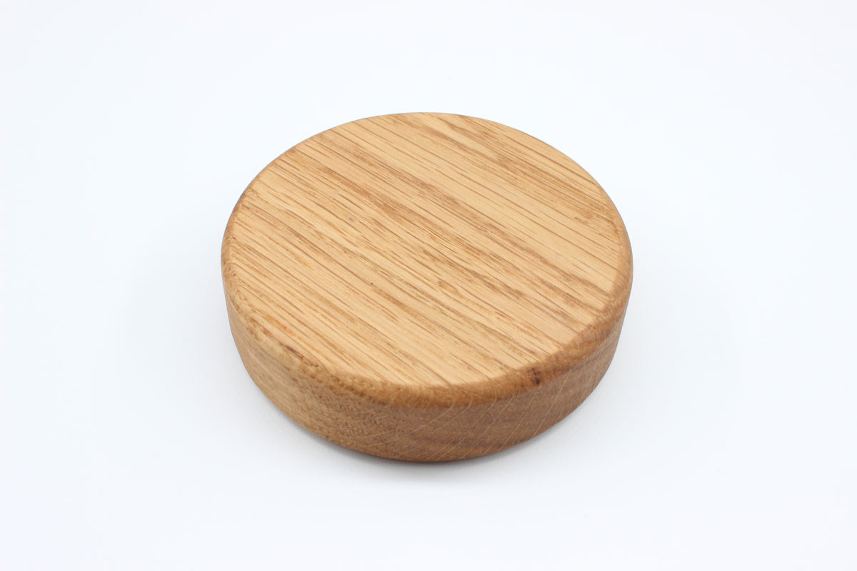 Back of solid oak magnetic puck-style bottle opener